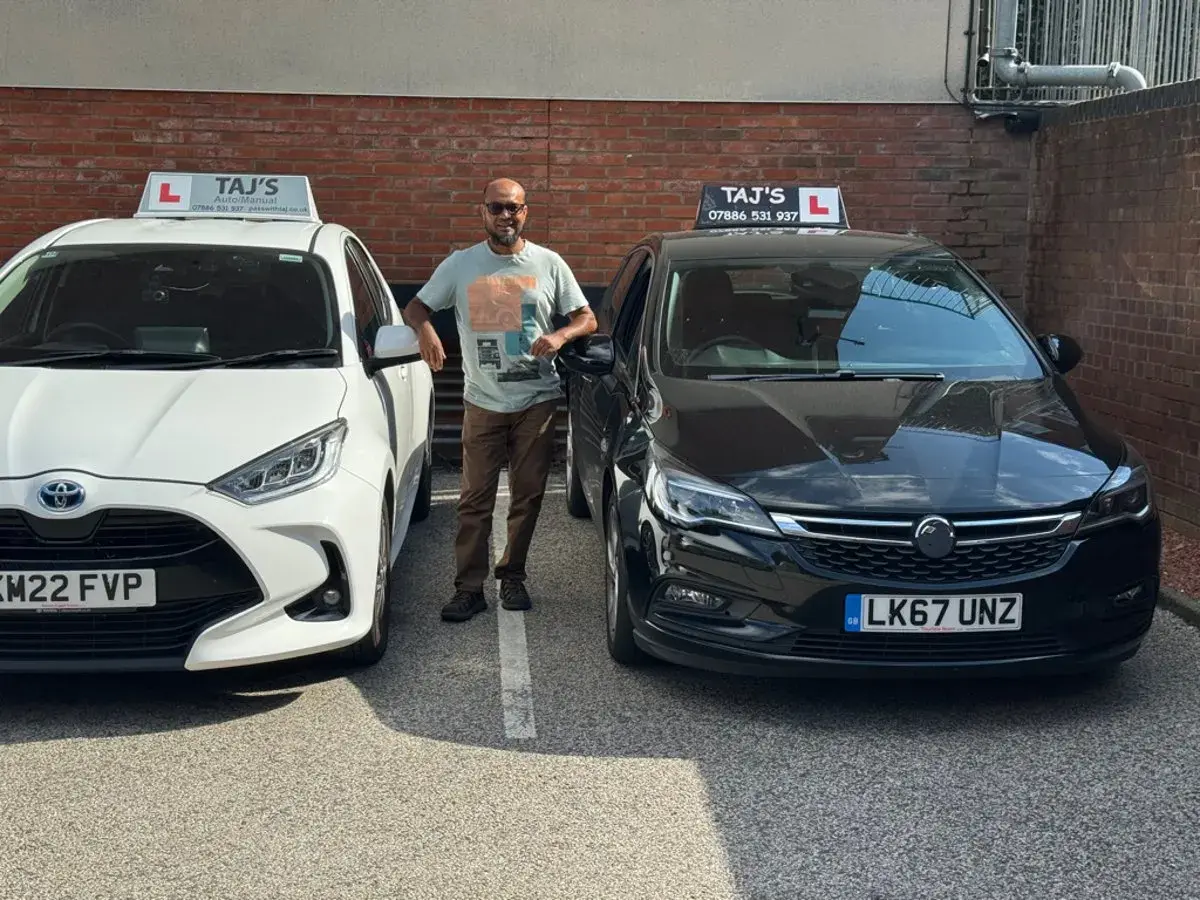 Taj with his two tuition cars